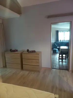 a living room with a dresser and a dining room at gite tout confort in Montolieu