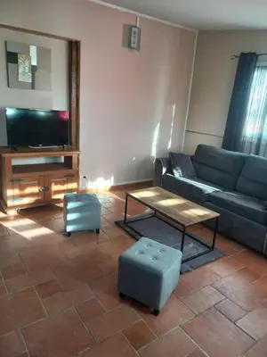 a living room with a couch and a table at gite tout confort in Montolieu