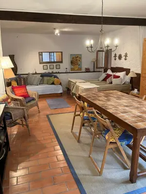 a living room with a table and a couch at L'Ecurie in Paziols