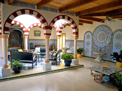 a living room with arches and tables and potted plants at Holiday Home Les Ecuries by Interhome in Alet-les-Bains
