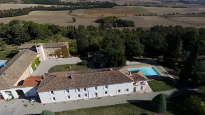 an aerial view of a large white house with a swimming pool at La Ginelle - Appartement Guy in Airoux