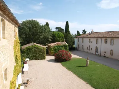 a driveway leading to a house and a yard at La Ginelle - Appartement Bocage in Airoux