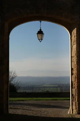an archway with a light in a building with a window at La Ginelle - Appartement Bocage in Airoux