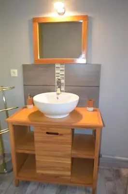 a bathroom with a sink and a mirror at L'Amandier in Maury