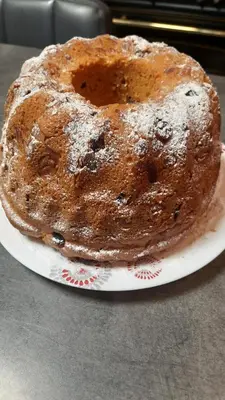a cake sitting on a plate on a table at L'Amandier in Maury