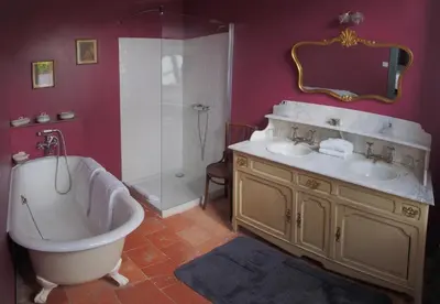 a bathroom with a tub and two sinks and a shower at Logis Hotel - Restaurant La Marbrerie in Caunes-Minervois