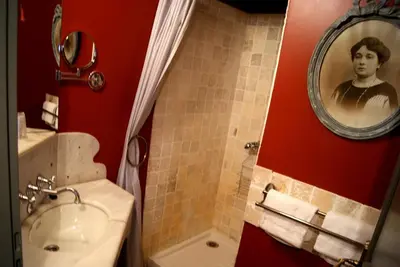 a bathroom with a sink and a mirror at Logis Hotel - Restaurant La Marbrerie in Caunes-Minervois