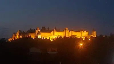 a large building is lit up at night at LE CLOS DES COLVERTS in Campagne-sur-Aude