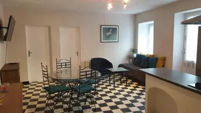 a living room with a glass table and chairs at LE CLOS DES COLVERTS in Campagne-sur-Aude