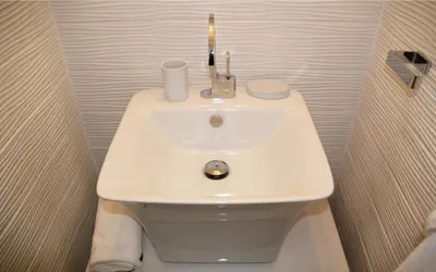 a white bathroom sink with a candle on it at Les Suites du Saint Nazaire, vue panoramique sur la Cité Médiévale - Les Balcons de la Cité in Carcassonne