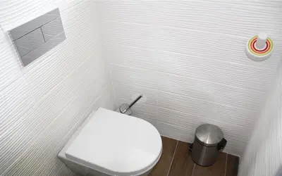 a bathroom with a white toilet and a trash can at Les Suites du Saint Nazaire, vue panoramique sur la Cité Médiévale - Les Balcons de la Cité in Carcassonne