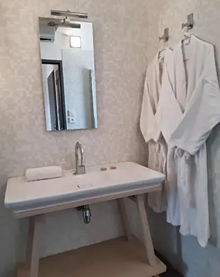 a bathroom with a sink and a mirror at Les Suites du Saint Nazaire, vue panoramique sur la Cité Médiévale - Les Balcons de la Cité in Carcassonne