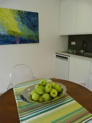 a plate of apples on a table in a kitchen at Maison Pigeonnier in Alet-les-Bains