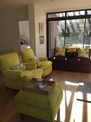 a living room with yellow chairs and a coffee table at Maison Pigeonnier in Alet-les-Bains