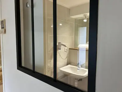 a bathroom with a sink and a mirror at Kyriad Carcassonne - Aéroport in Carcassonne
