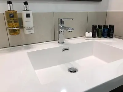 a white sink with a faucet on a counter at Chateau Marcel in Cesseras