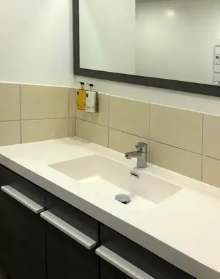 a bathroom with a white sink and a mirror at Chateau Marcel in Cesseras