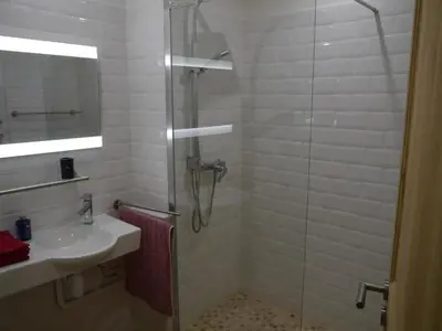 a bathroom with a shower and a sink at Aux 4 FONTAINES in Narbonne