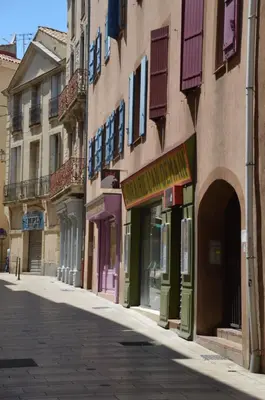 an empty street in a city with buildings at Aux 4 FONTAINES in Narbonne