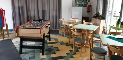a room with a giant chess board and tables and chairs at Résidence les Mélèzes de Prades Ariège in Prades