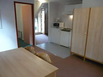a kitchen with a dog laying on the floor at Résidence les Mélèzes de Prades Ariège in Prades