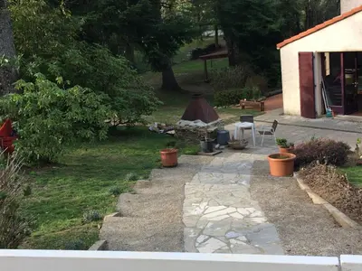 a garden with a tent in the back of a yard at Studio duplex 1 Lac des Montagnès in Mazamet