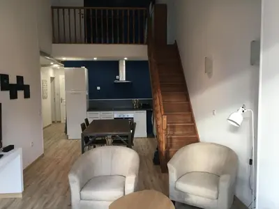 a living room with a table and two chairs at La cathare appartement in Lézignan-Corbières