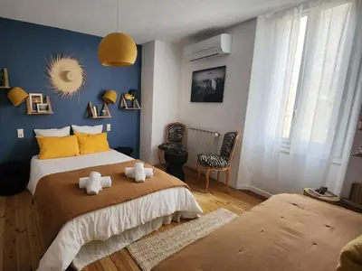 a bedroom with two stuffed animals on a bed at Chambres d'Hôtes et Gîtes- L'Abri sous Roche in Tautavel