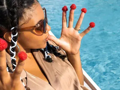 a woman holding up her hands while eating raspberries at Greet Hôtel Castres Saix in Saix