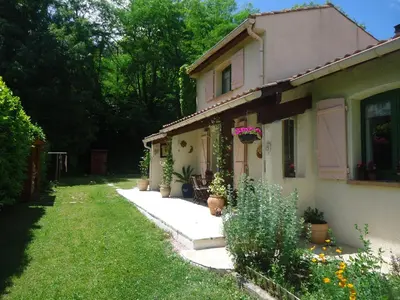 a house with potted plants on the side of it at KiOui in Rennes-les-Bains