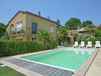 a swimming pool in front of a house at Spacious Villa Retreat in Carcassonne in Carcassonne