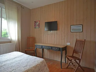 a bedroom with a bed and a desk and a television at Spacious Villa Retreat in Carcassonne in Carcassonne