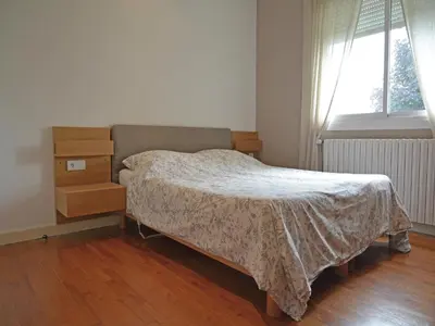 a bedroom with a bed and a dresser and a window at Spacious Villa Retreat in Carcassonne in Carcassonne
