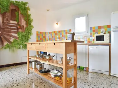 a kitchen with a wooden counter with pots and pans at Holiday Home Talairan with Pool and BBQ in Talairan