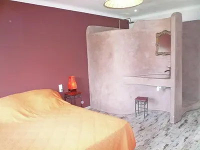 a bedroom with a bed and a painting on the wall at Holiday Home Talairan with Pool and BBQ in Talairan