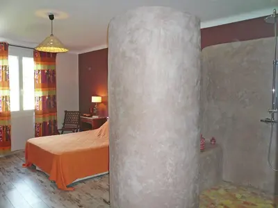 a bedroom with a shower and a bed in a room at Holiday Home Talairan with Pool and BBQ in Talairan