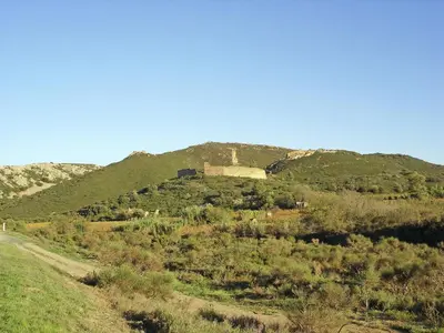 a building on top of a hill with a dirt road at Holiday Home Talairan with Pool and BBQ in Talairan