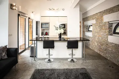 a kitchen with a counter with stools in a room at 45BB in Carcassonne