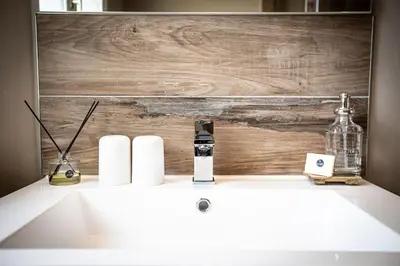 a bathroom sink with a wooden wall behind it at 45BB in Carcassonne