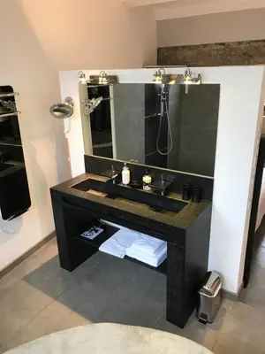 a bathroom with a black sink and a mirror at 45BB Apartment in Carcassonne