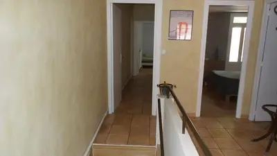 a hallway with a staircase leading to a bathroom at spacieux logement face à la Cité Médievale in Carcassonne