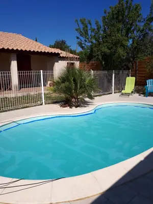 a swimming pool in front of a house at Méditerranée in Sigean