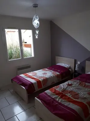 a bedroom with two beds and a window at Méditerranée in Sigean