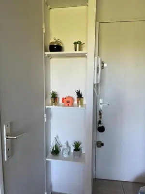 a room with a door with plants on shelves at LE MONICA in Narbonne