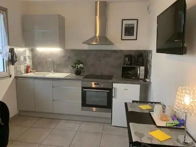 a kitchen with a sink and a stove top oven at LE MONICA in Narbonne