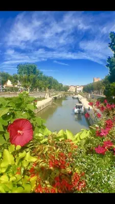 a view of a river with a boat on it at LE MONICA in Narbonne