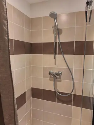 a shower with a shower head in a bathroom at Studio Meublé non fumeur in Narbonne