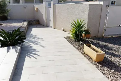 a walkway in front of a house with plants at Studio Meublé non fumeur in Narbonne