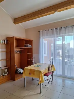 a dining room with a table and a window at Studio Meublé non fumeur in Narbonne