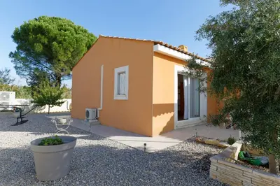 a small house in a yard with a patio at Studio Meublé non fumeur in Narbonne